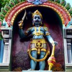 Kuruppuswamy with detailed stone carvings, statues, and traditional architecture.