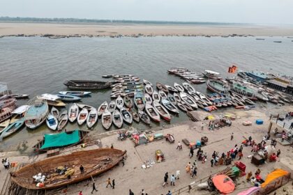 A picture of Kashi with its serene ghats and ancient temples in the background.