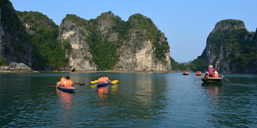 A serene image depicting kayakers exploring calm waters near Diveagar Beach amidst nature