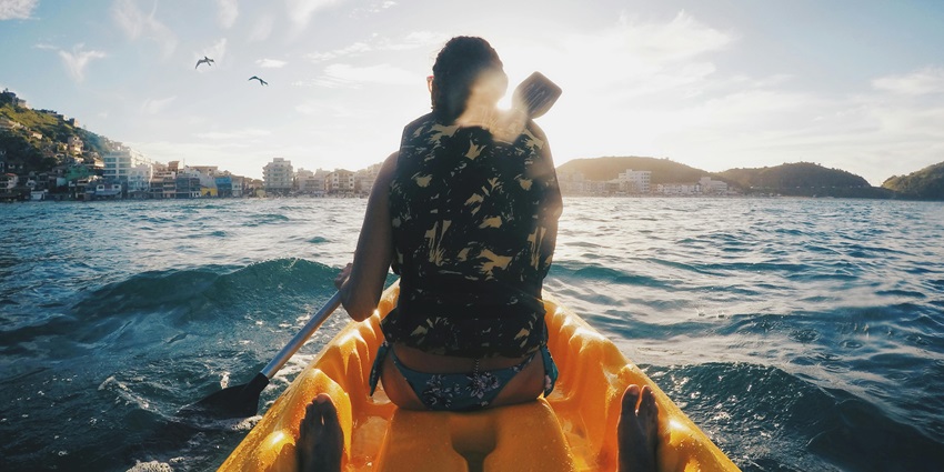 A serene image depicting kayakers exploring calm waters near Kihim Beach amidst nature.