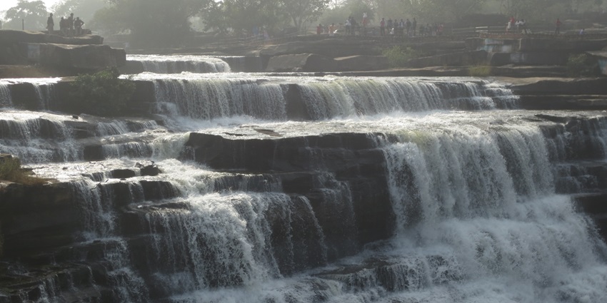 A picture of a waterfall with water cascading down the rocky structures