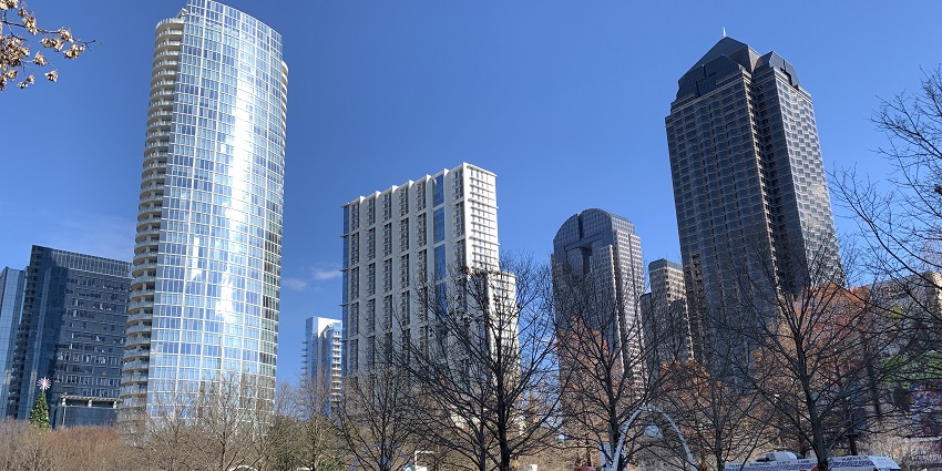 Klyde Warren Park with dried winter trees, multiple food trucks surrounded by skyscrapers