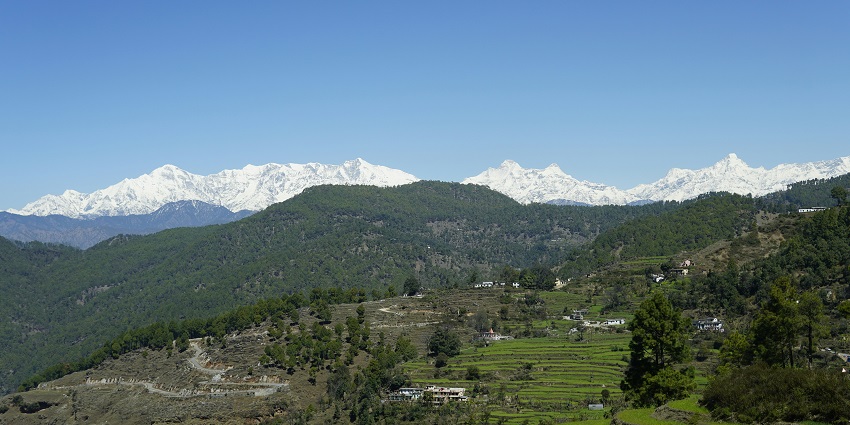 An astonishing view of Kolhuchaur featuring green-capped mountains and forests.
