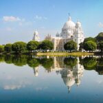 An image of Victoria Memorial Hall, Kolkata, a large white building sitting on top of a lake.