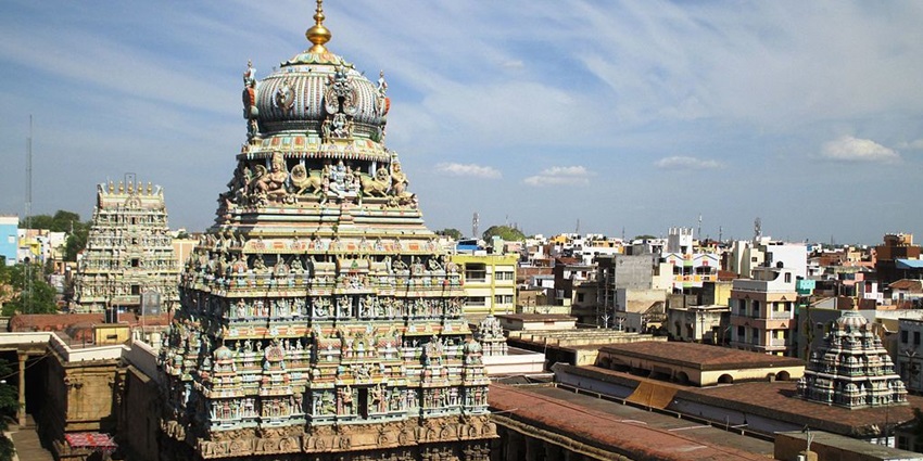 Koodalazhagar Temple amidst a town with detailed sculptures and vibrant structures visible.