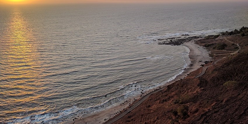 An image of a beautiful sunset at Korlai Beach, a famous tourist attraction.