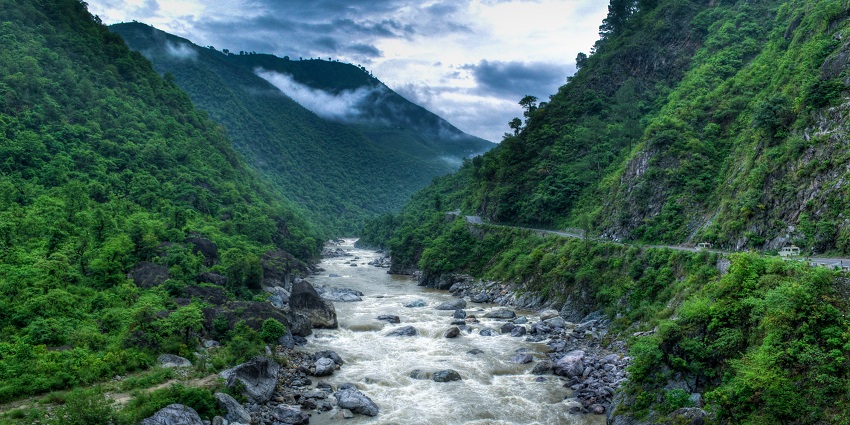 Serene River flowing through forests, popular for scenic views at kosi river,Uttarakhand.