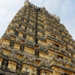 Kothandaramar temple and its towering gopuram with intricate carvings against clear sky.