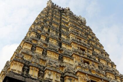 Kothandaramar temple and its towering gopuram with intricate carvings against clear sky.