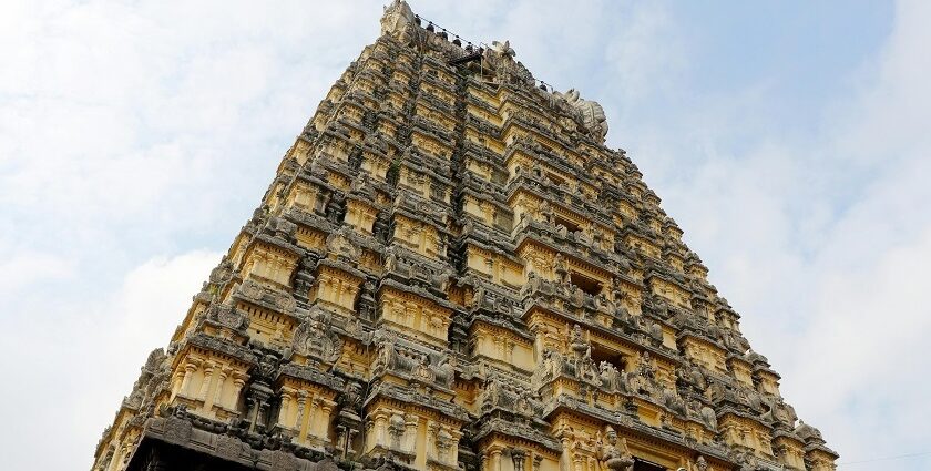 Kothandaramar temple and its towering gopuram with intricate carvings against clear sky.