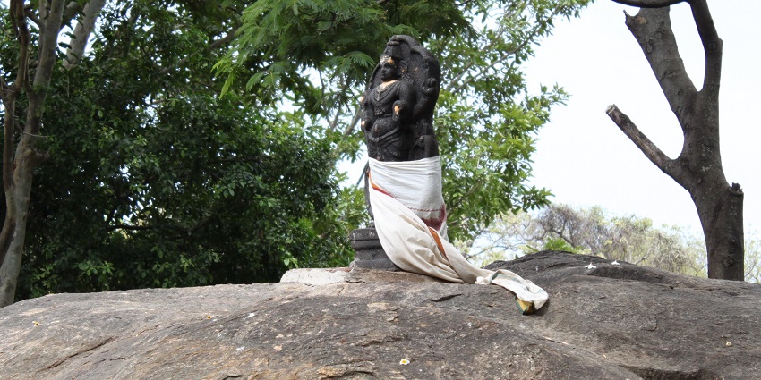 An image of Kumbakarai Murugan Temple, nestled amidst greenery and hills in Tamil Nadu