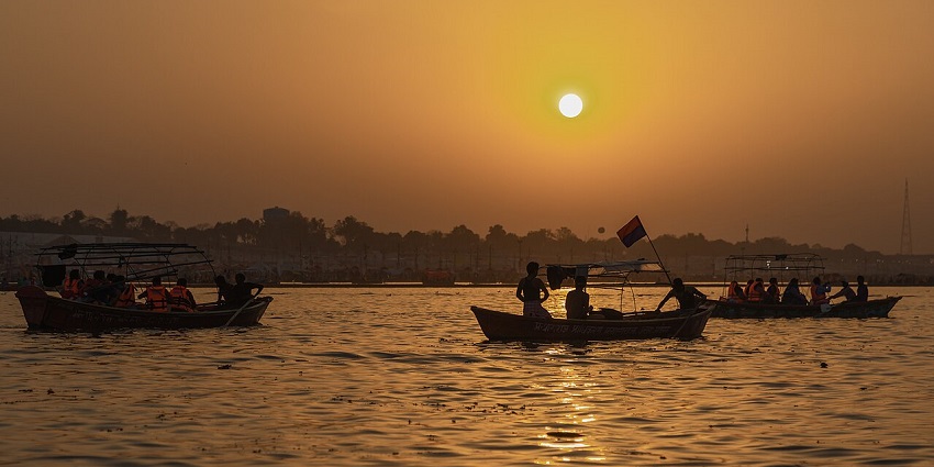 Tourists enjoying boat riding on the confluence of the three rivers