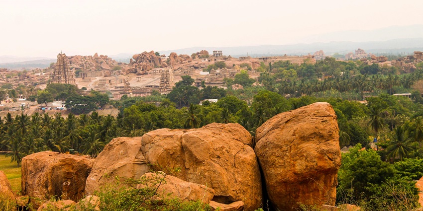 An image showing a landscape of mountains and temples like Kunnathur Devi Temple.