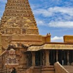 Lalithambigai Temple with a tall flagstaff in the foreground and gates with intricate details