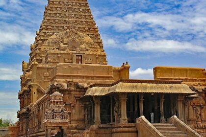 Lalithambigai Temple with a tall flagstaff in the foreground and gates with intricate details