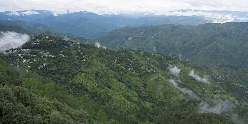 Lush green landscape of Lansdowne with hills and cloudy sky in view–place to visit near haridwar