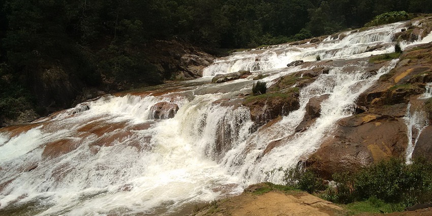 Picturesque waterfalls surrounded by lush greenery and tranquility