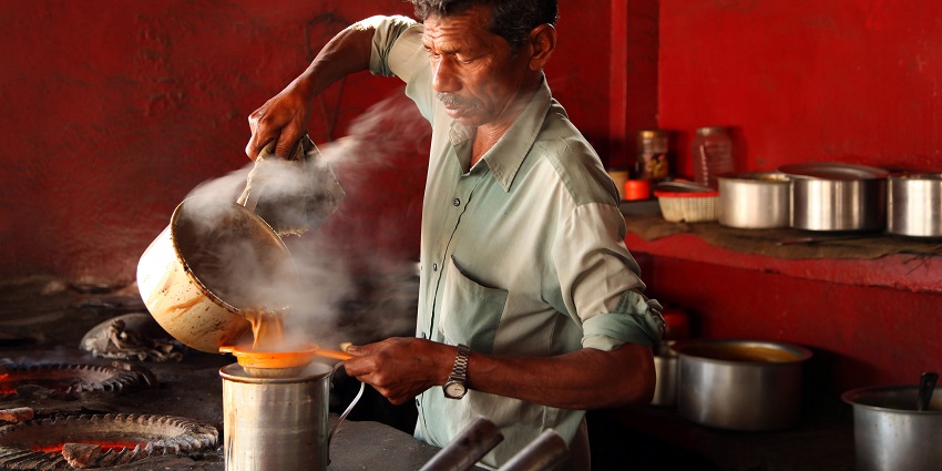Vendor making chai, one of the best and chosen famous street foods in Varanasi.