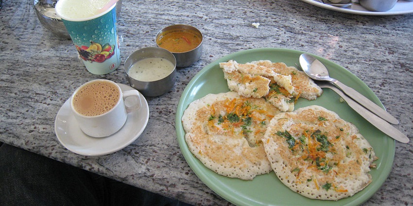 A classic South Indian meal with dosa and coffee.