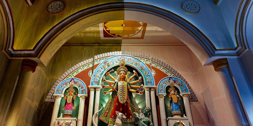 An image of Lehra Devi Temple contains a statue of Maa Durga, within a large structure.