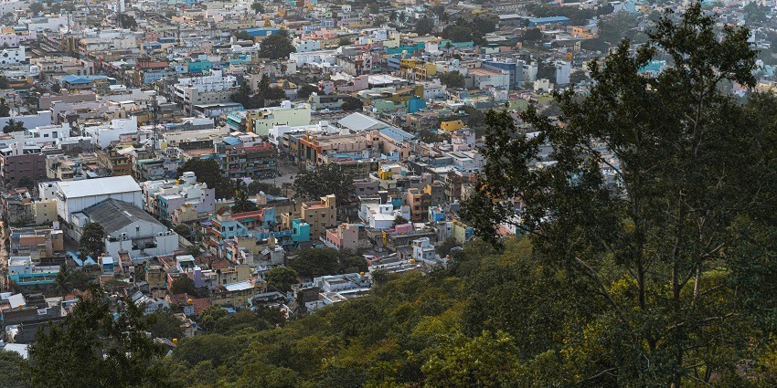 Aerial view of a city with high-rise buildings in neighbourhoods and surrounding greenery.