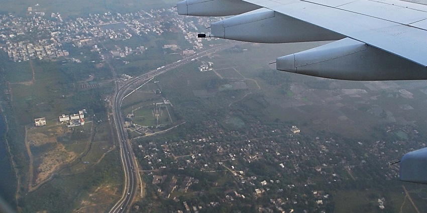 Aerial view of Sriperumbudur town with roads, buildings, greenery, and NH4 highway