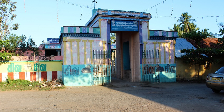 Konerirajapuram temple with stairs leading to the complex area surrounded by trees.