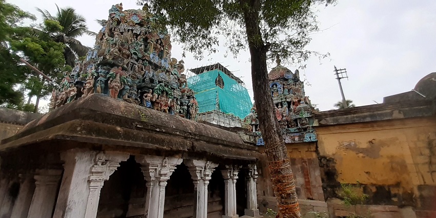 An outer view of a temple that has been vibrantly painted and has intricate carvings