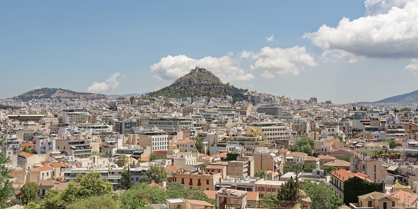 Athens town from Anafiotika with Vibrant buildings and Lycabettus Hill in the background.
