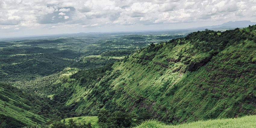 An image of the lush green region where the fort is located in Nashik, Maharashtra.