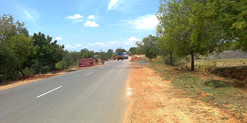 Thirumuruganpoodi road leading to the Thirumuruganpoondi temple, surrounded by trees