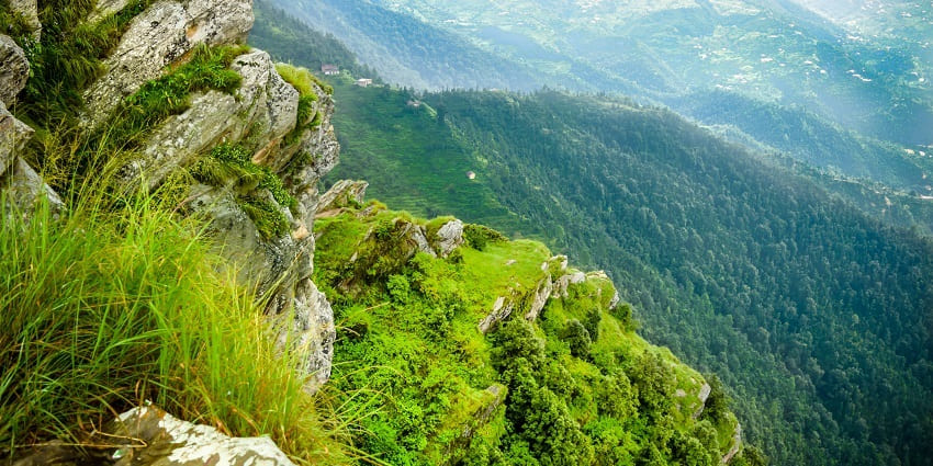 A view of the lush greenery and mountains near Bhalu Gaad Waterfalls