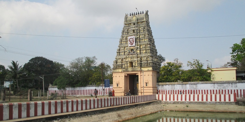 Outside of Subramanaya Swamy temple with the temple’s still water reflecting the structure.