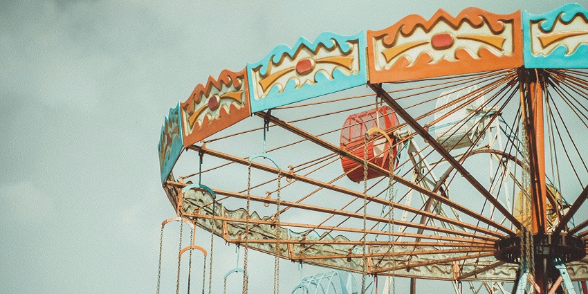 A thrilling amusement park ride with colourful lights, capturing the fun of the fair.