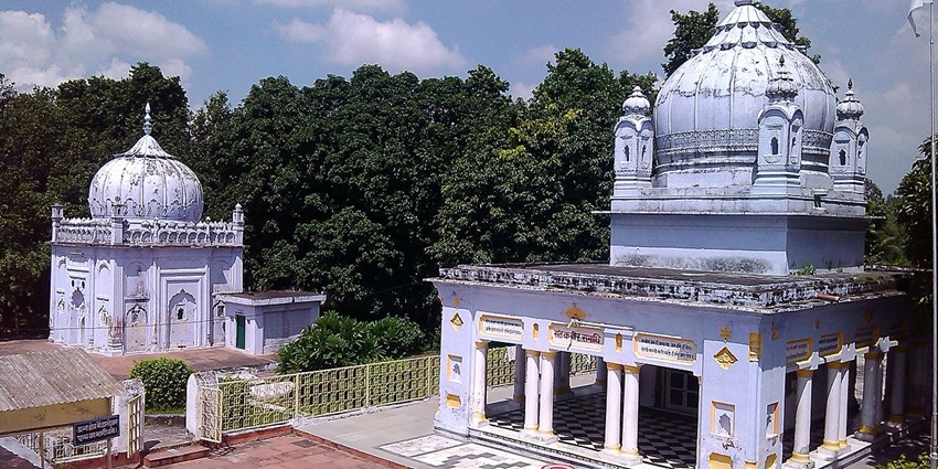 Front view of Kabir Chaura in Maghar with visitors near the entrance and temple structure.