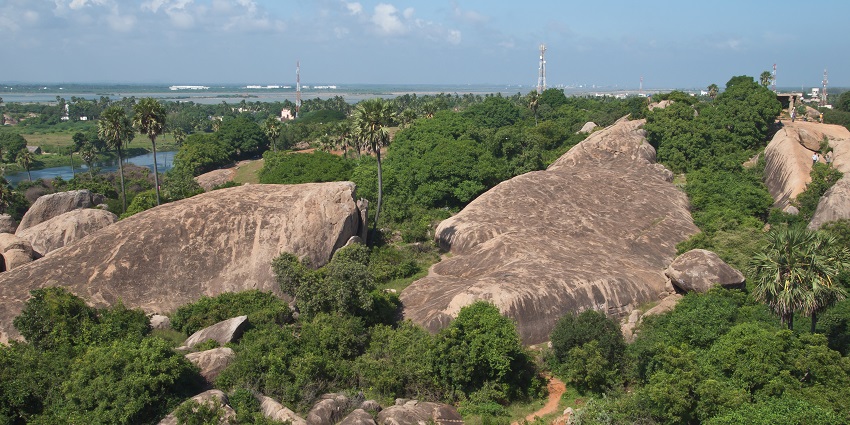 Mahabalipuram landscape with huge stones and rocks covered in greenery and pathways