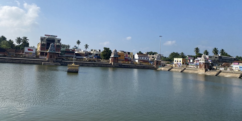View of a Mahamaham Tank showing a large reservoir of water surrounded by the building