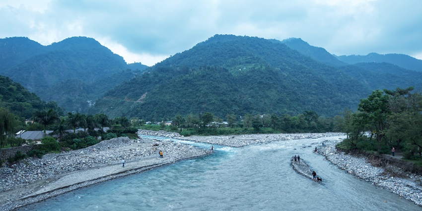 Scenic picnic spot with riverside views, lush greenery, and a peaceful natural setting.