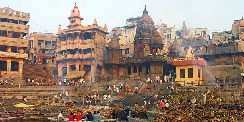 Historic Manikarnika Ghat in Varanasi with boats along the Ganges, a sacred site.