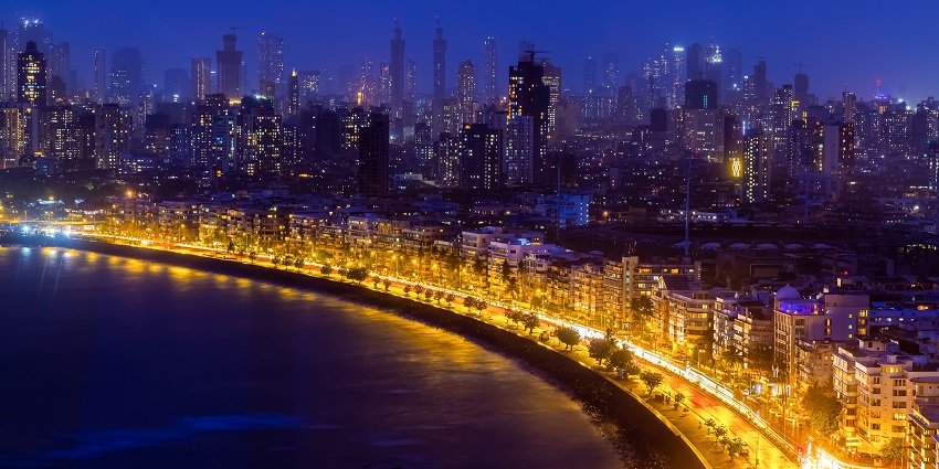 View of the marine drive at night, illuminated by the city lights