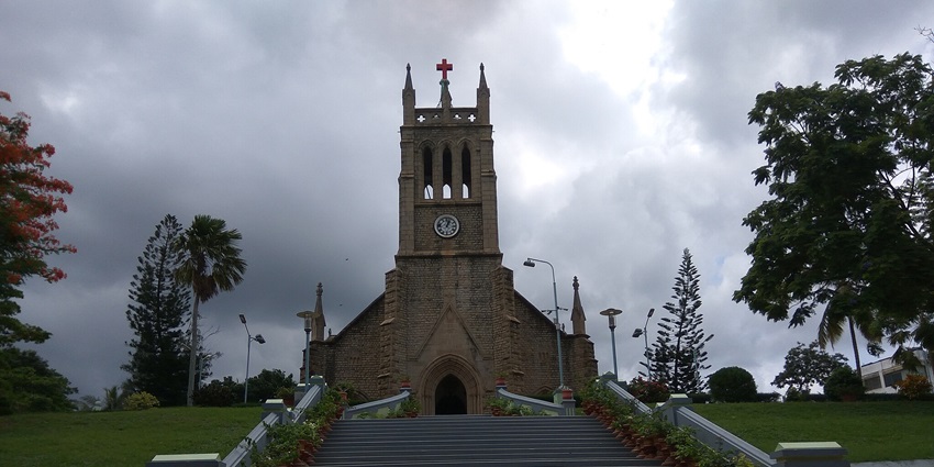 Image of the historic Marthandam CSI Church with white walls and a prominent bell tower.