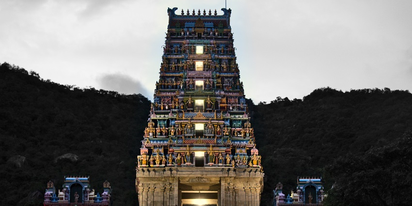 Marudhamalai Murugan Temple with colourful structure and bright lights in the evening.