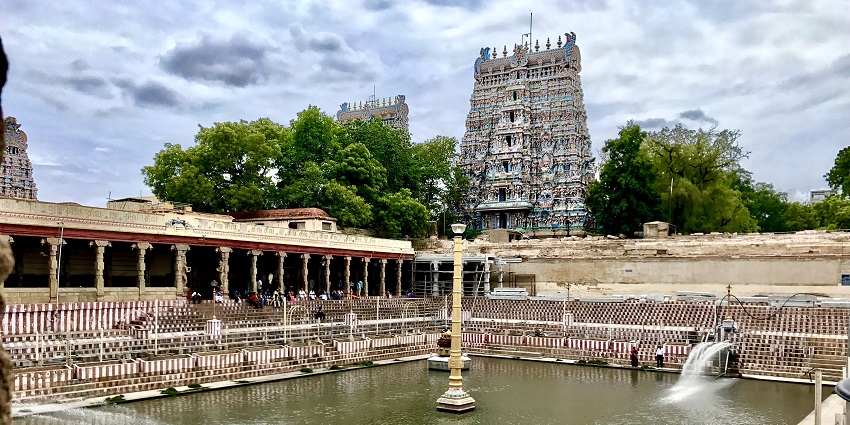 View of the temple tank at Meenakshi Amman Temple, surrounded by ornate pillars.