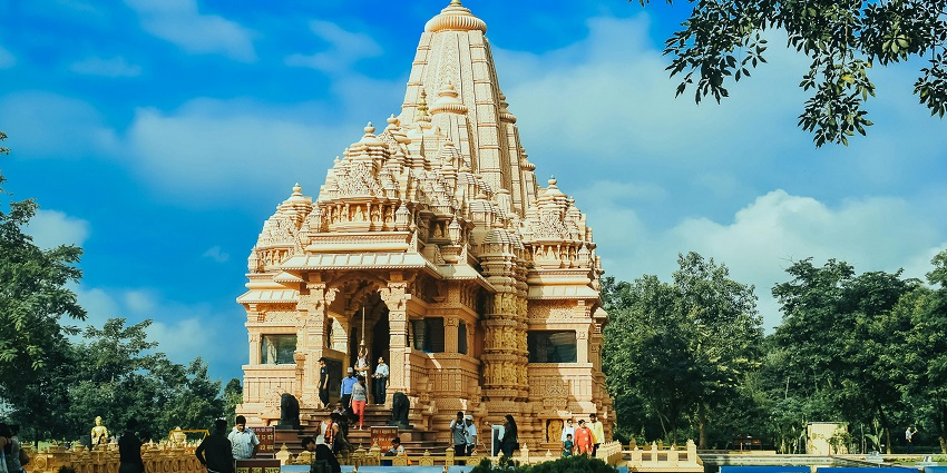 An image of a beautifully decorated temple in Modinagar that has a golden spire.