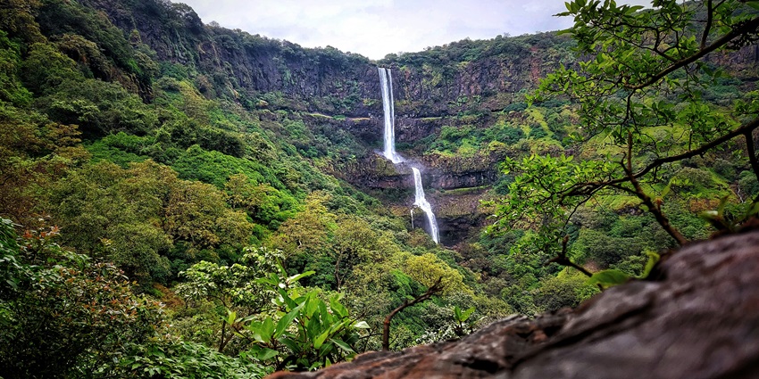 A scenic view of the Morni Hills Waterfalls, one of the top places to visit near Rohtak.