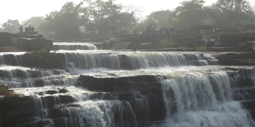 Scenic view of Waterfall surrounded by lush greenery in Uttar Pradesh, India.