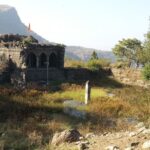 Scenic image of Mulher Fort, located in the Sahyadri mountain range, showing its old architecture.