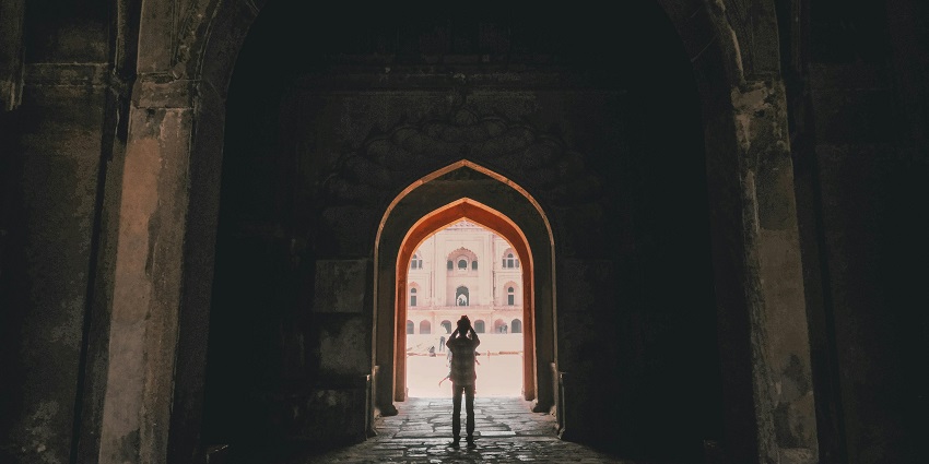 A visitor exploring the intricate architecture of a popular spot near Tringalwadi Fort.