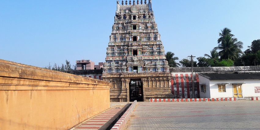 A distant view of a stunning temple with intricate carving on its multiple upper layers