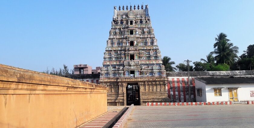 A distant view of a stunning temple with multiple upper layers in vibrant colours.